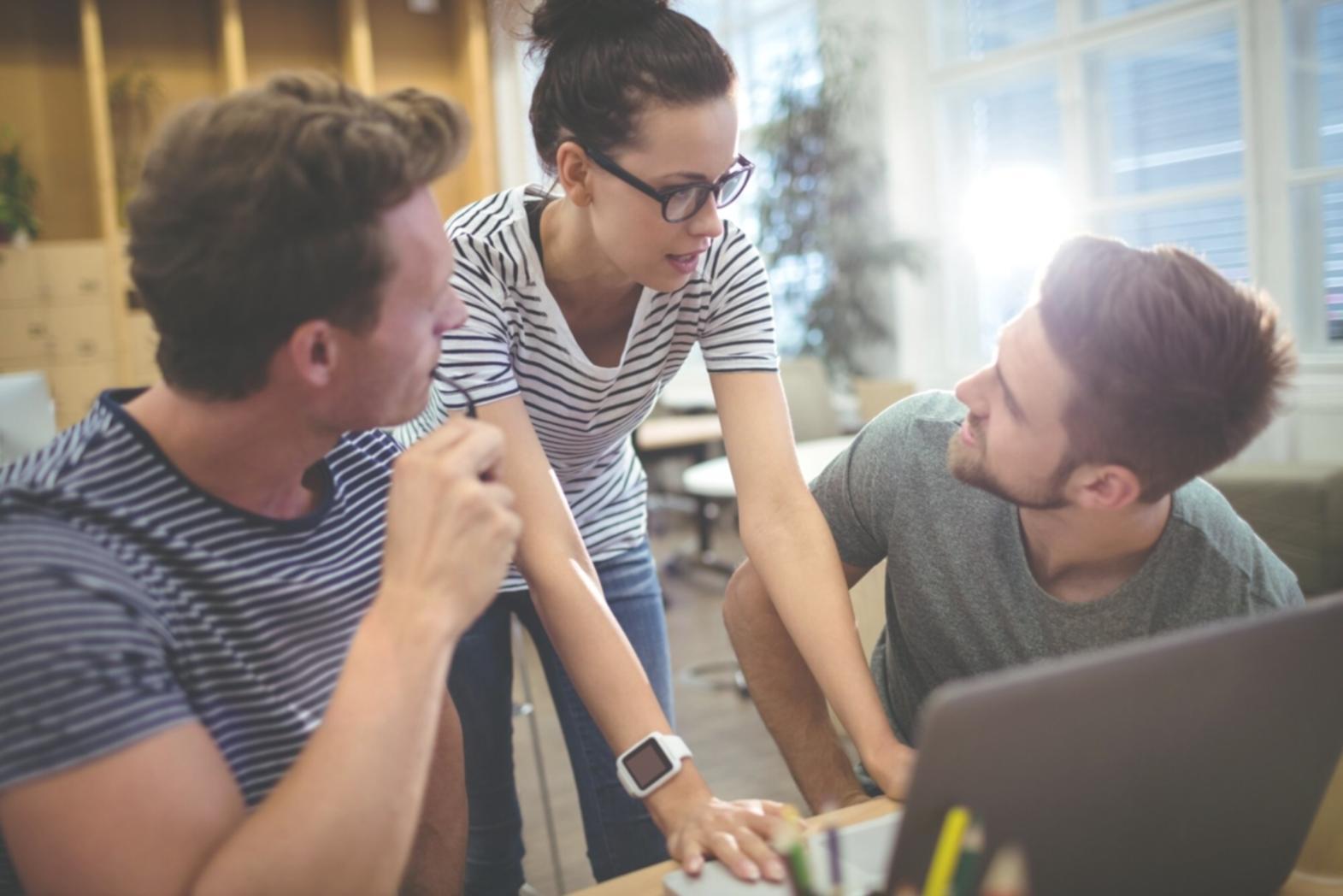 Modern office environment showcasing professional investment evaluation workspace with multiple monitors displaying financial data